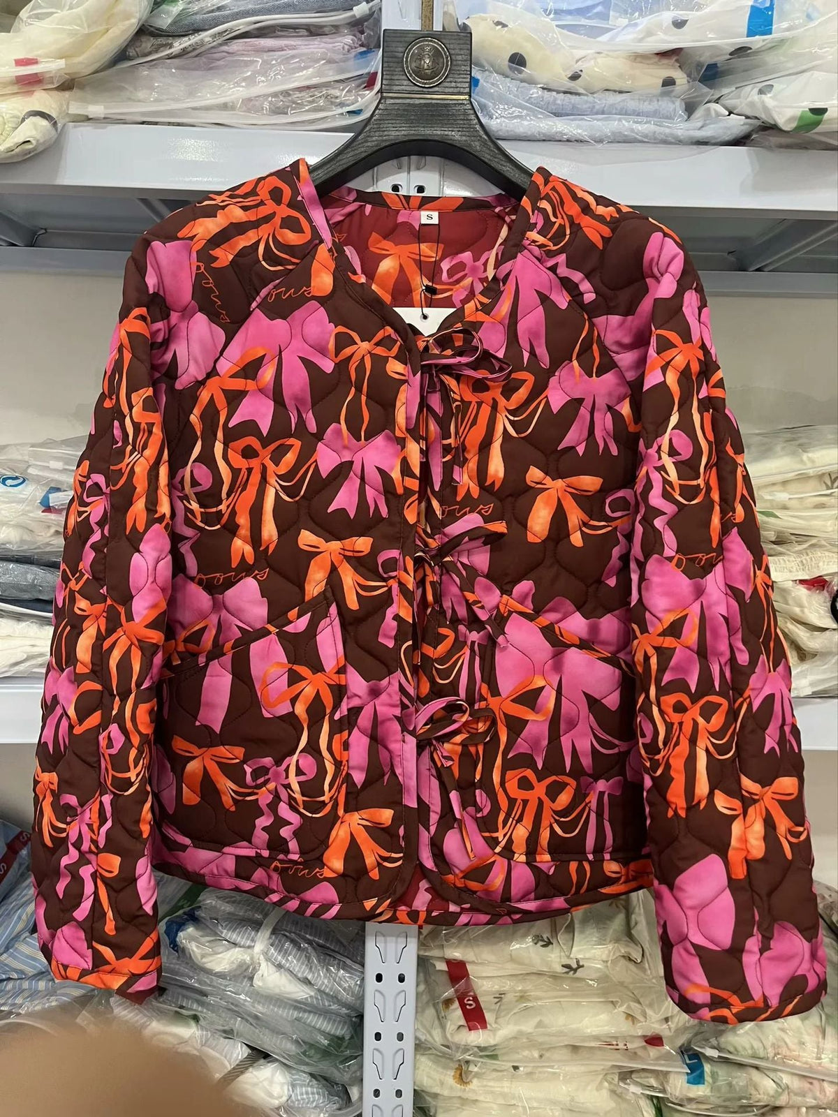 Women's quilted jacket with playful bow pattern NOVAE