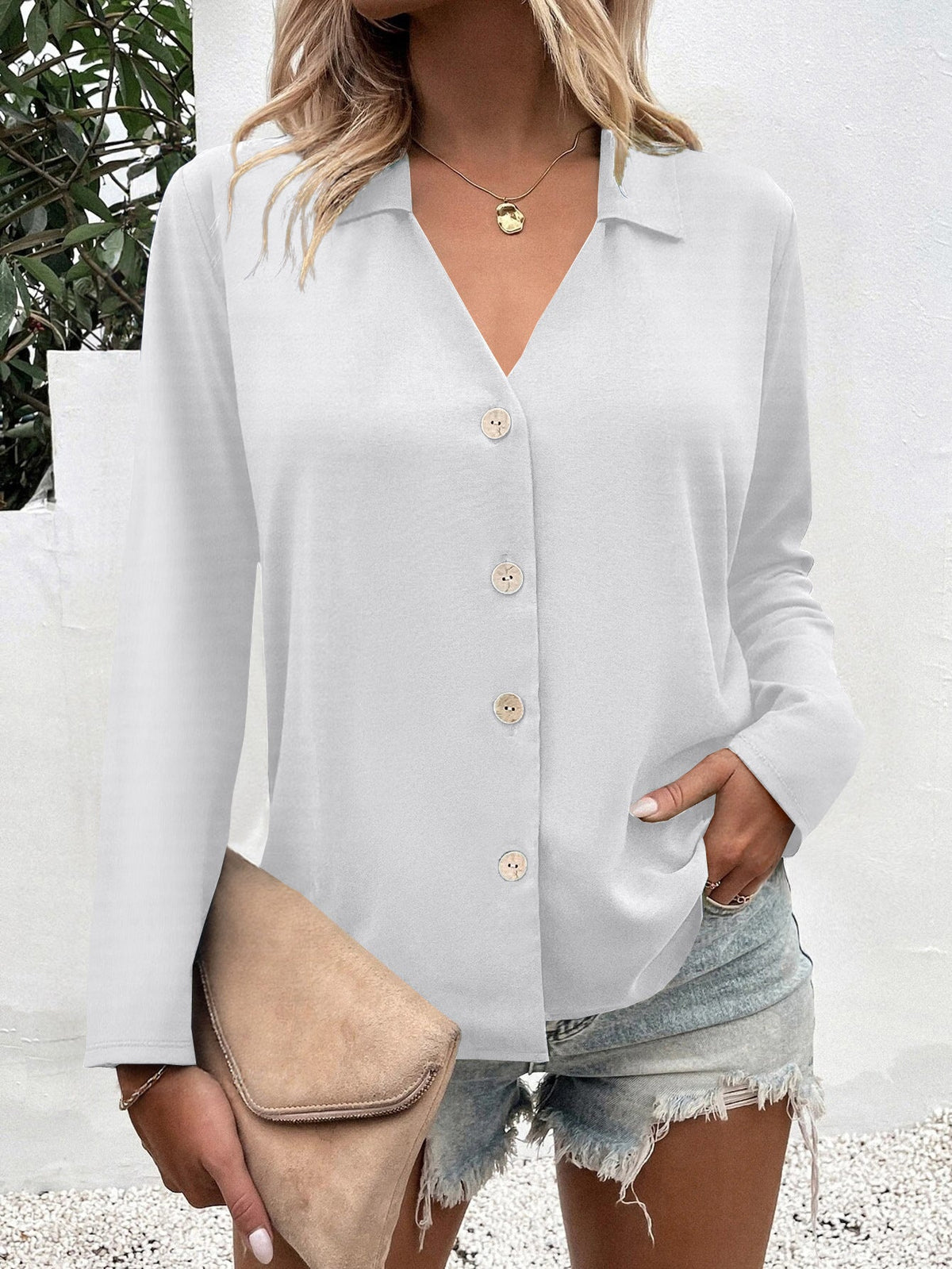 Women's fashionable blouse with V-neck and button details NOVAE