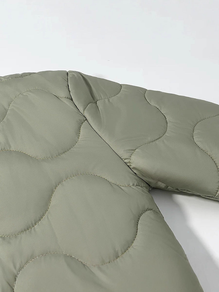 Women's quilted transitional jacket with soft fabric texture and practical snap fasteners NOVAE