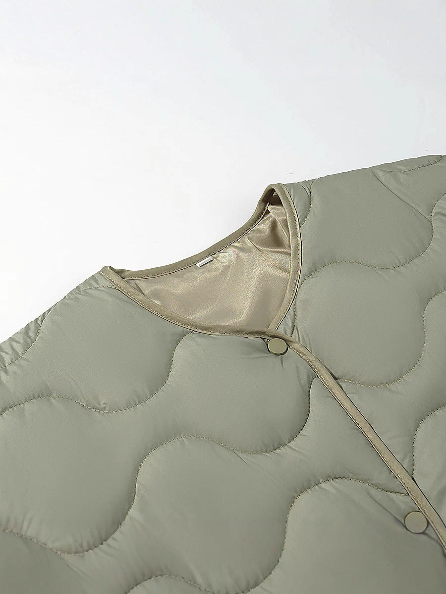 Women's quilted transitional jacket with soft fabric texture and practical snap fasteners NOVAE