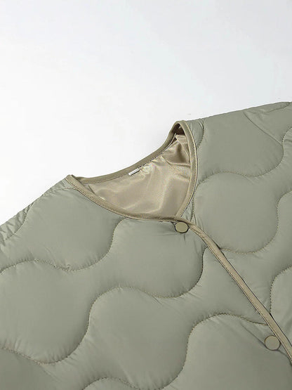 Women's quilted transitional jacket with soft fabric texture and practical snap fasteners NOVAE